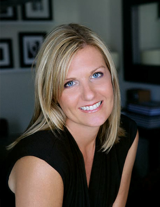 The image features a woman with blonde hair, wearing a black top, smiling at the camera, and posing for a portrait.