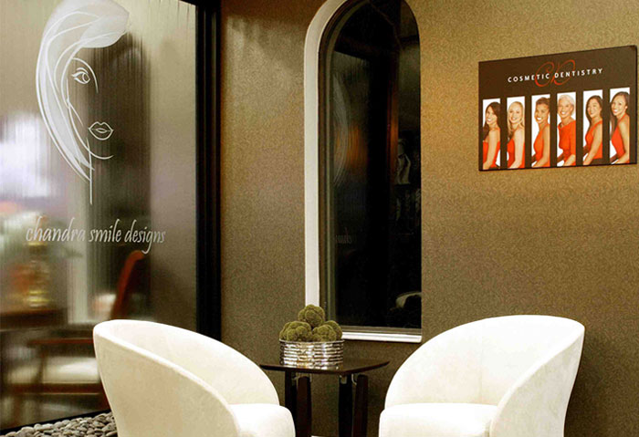 The image shows an interior space with a blurred background, featuring a modern salon or barber shop environment.